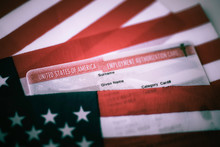 Employment Authorization Card Covered Of USA Flag. Close Up View. Toned Photo.