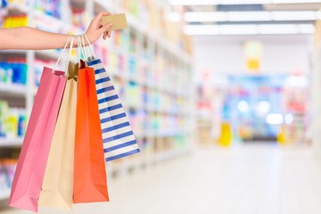 Poster - Close up woman hand with many shopping bags and credit card