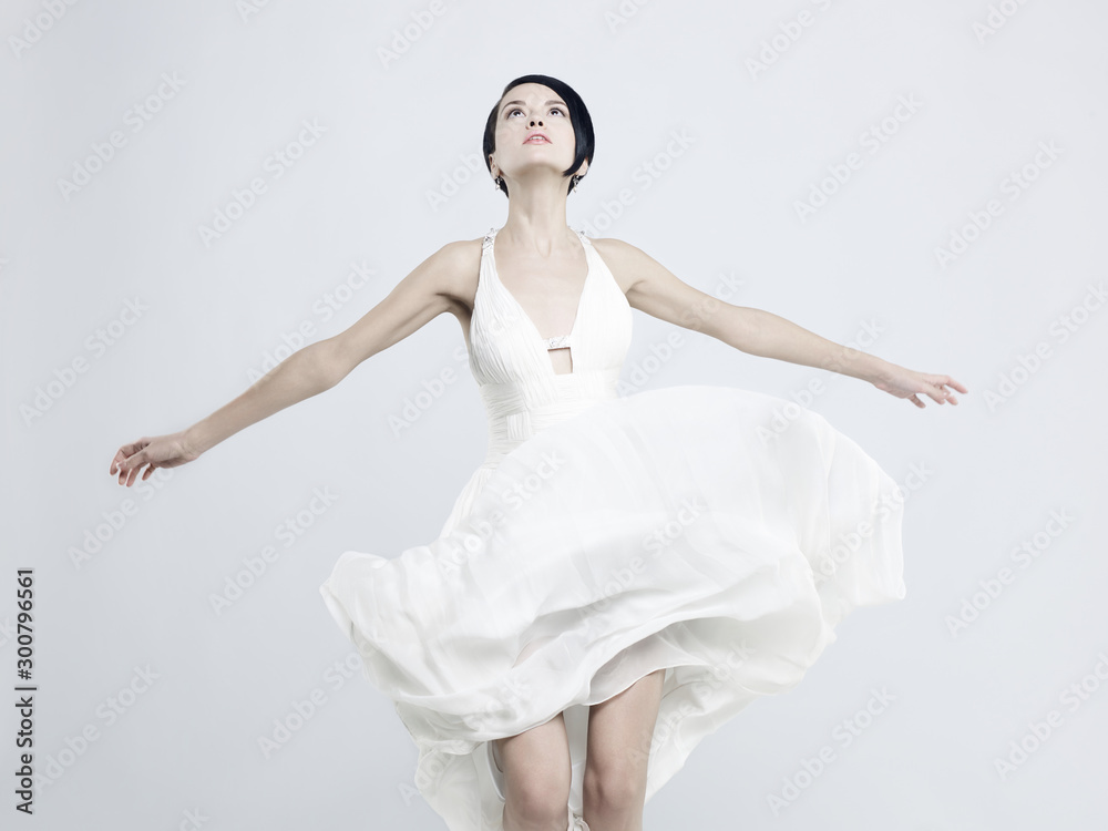 Beautiful young lady in a billowing white dress - obrazy, fototapety, plakaty 