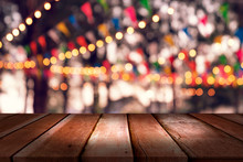 Top Desk With Blur Restaurant Background,Wooden Table And Blurred Bokeh Of Night Street Background
