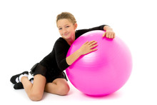 Little Girl Doing Exercises On A Big Ball For Fitness.
