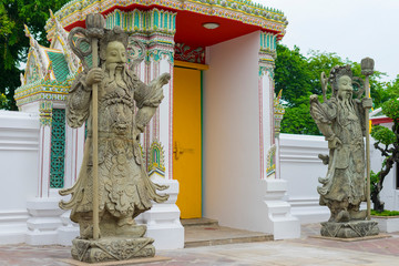 Wall Mural - Stone carving of giants in front of the gate of Wat Pho in Bangkok, Thailand.  B