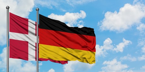 Canvas Print - Denmark and Germany flag waving in the wind against white cloudy blue sky together. Diplomacy concept, international relations.