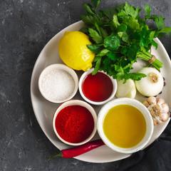 Canvas Print - Ingredients for cooking Argentinian green Chimichurri or Chimmichurri salsa or sauce made of parsley, chili pepper, olive oil, garlic and vinegar