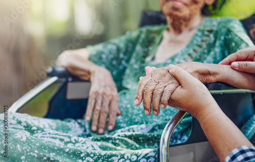 Fotomural Elderly asian woman on wheelchair at home with daughter take care