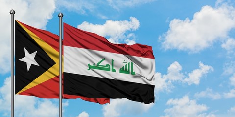 East Timor and Iraq flag waving in the wind against white cloudy blue sky together. Diplomacy concept, international relations.