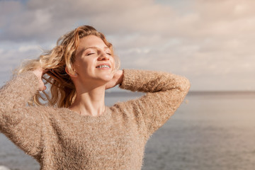 Happy woman outdoor wearing jumper