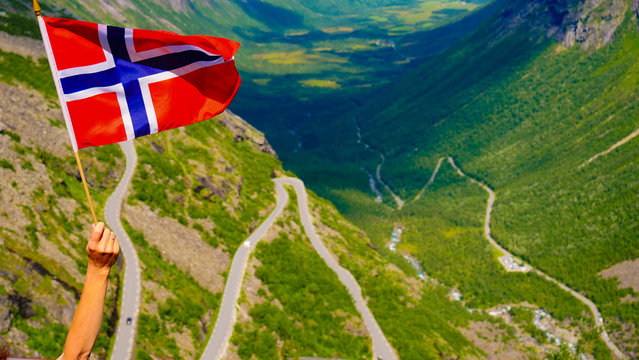 Norwegian flag and Trollstigen mountain road