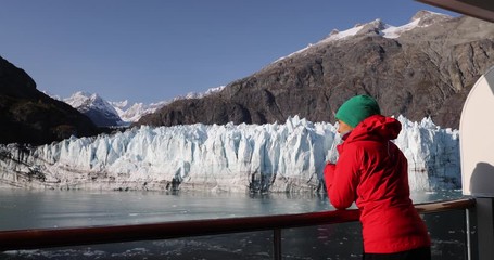 Wall Mural - Alaska cruise ship passenger photographing glacier in Glacier Bay National Park, USA. Woman tourist taking photo picture using smart phone on travel vacation. Margerie Glacier.