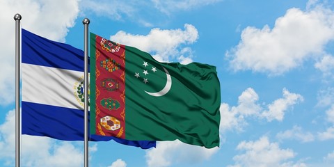 El Salvador and Turkmenistan flag waving in the wind against white cloudy blue sky together. Diplomacy concept, international relations.
