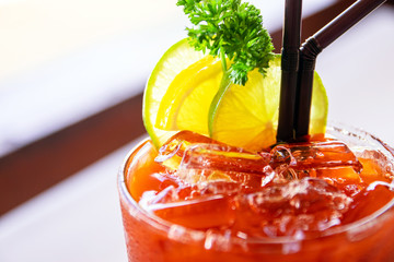 Wall Mural - Close up of ice black tea with lemon slice; summer drink mocktail.