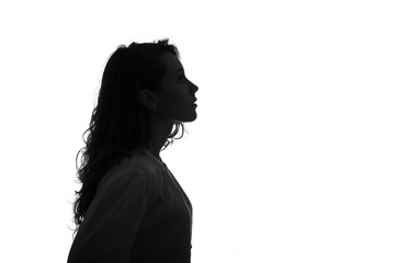 silhouette portrait of a beautiful young girl with long hair isolated on white background.