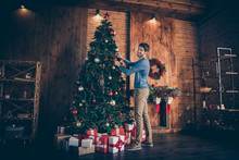 Full Length Body Size Turned Photo Of Cheerful Funky Positive Man Hanging Toys Onto Tree In Pants Trousers Shoes Smiling Toothily Looking At Camera
