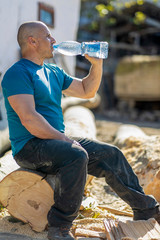 Wall Mural - Thirsty lumberjack drinking water and having a break