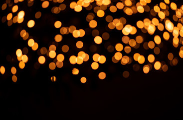 Golden bokeh on a black background. Abstraction