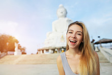 Young Smiling Girl Near Statue Of Buddha In Phuket, Thailand.
