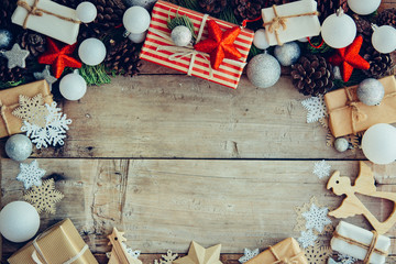 Wall Mural - Christmas background with gift boxes and decorations on the wooden table.