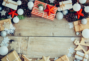Wall Mural - Christmas background with gift boxes and decorations on the wood
