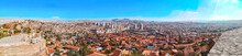 Top View Of The Old City And Modern District Of Turkey Capital From The Observation Deck Of Ankara Castle. Colorful Widescreen Panorama Of Residential Areas With Mountains And Fortress On The Horizon