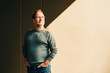 © annanahabed - Outdoor portrait of 50 - 55 year old man wearing green pullover and eyeglasses, light shade image