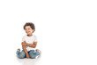 © LIGHTFIELD STUDIOS - Cheerful African American boy looking away while sitting on white background