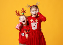 Happy Funny Surprised Emotional Children Boy And  Girl In Red Christmas Reindeer Costume   On Yellow   Background.