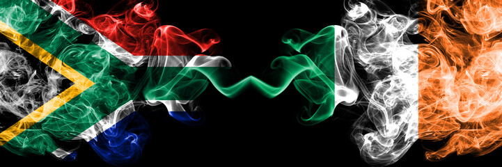 South Africa vs Ireland, Irish smoky mystic flags placed side by side. Thick colored silky abstract smoke flags concept