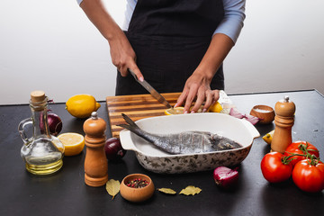 girl cooks dorado fish