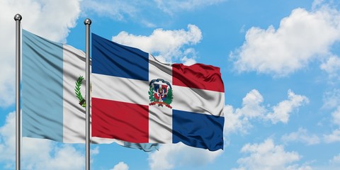 Guatemala and Dominican Republic flag waving in the wind against white cloudy blue sky together. Diplomacy concept, international relations.