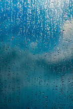 Rain Drops On Window Blue Background