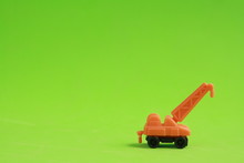 Plastic Toy With Crane Shape In Color Background