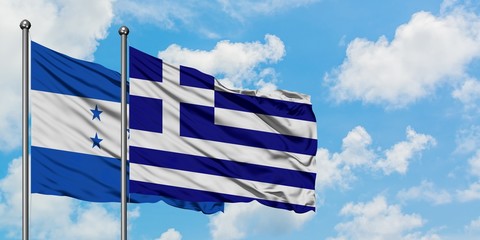 Honduras and Greece flag waving in the wind against white cloudy blue sky together. Diplomacy concept, international relations.