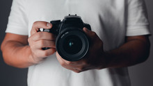 Photographer Holding A Digital Camera