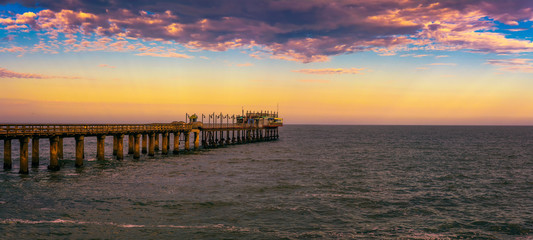 Wall Mural - Sunset over the old historic jetty in Swakopmund, Namibia