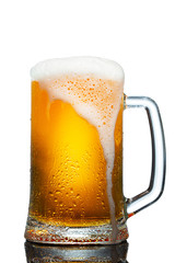 Wall Mural - cold mug of beer with foam isolated on white background