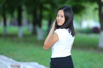 Young girl walking in the park are walking gait