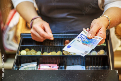 Cuadros en Lienzo woman is paying In cash with euro banknotes