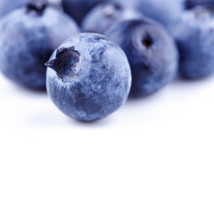 Wall Mural - Tasty juicy fresh bilberries close-up isolated on white background. Blueberry copyspace border design