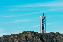 Maritime Lighthouse On Rocky Cliff On Atlantic Coast
