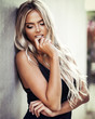 © Maksim Toome - Portrait of beautiful blond young woman in a classic black dress elegant clothes