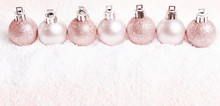 Christmas Composition. Pink And Silver Christmas Balls On Snow White Background.