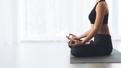 Wall Mural - Keep calm. Woman sitting in lotus position on floor