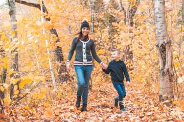 Wall Mural - A portrait of a mother with child in the autumn park