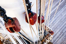 Ship Ropes Tied To The Mast Before Lowering Sails.