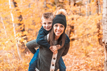 Wall Mural - A portrait of a mother with child in the autumn park