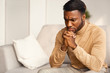 © Prostock-studio - Unhappy Black Man Thinking Sitting On Couch At Home
