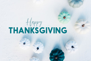 Happy Thanksgiving holiday banner with flat lay of trendy pumpkins on white background.