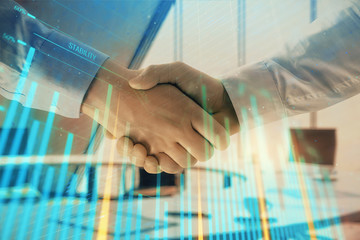 Multi exposure of financial graph on office background with two businessmen handshake. Concept of success in business