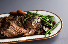 Slow Cooked Beef Roast With Carrots And Green Beans With Thyme Garnish. 