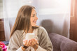 © de Art - a girl in a cafe holding a mug of coffee